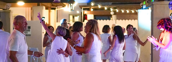 People dancing at an evening social event at The Paseo Club