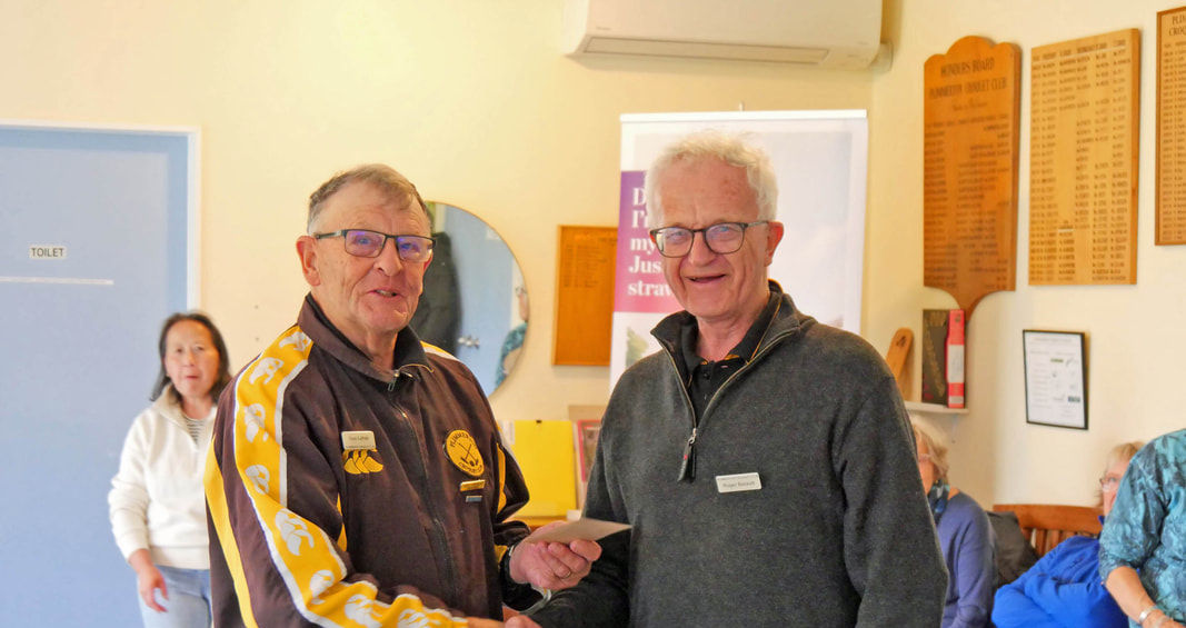 Two men shaking hands at an award presentation