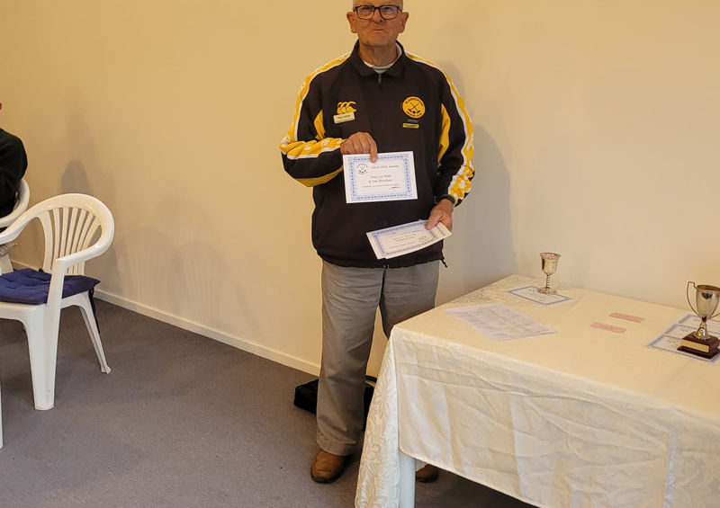 Man in jacket holding certificate