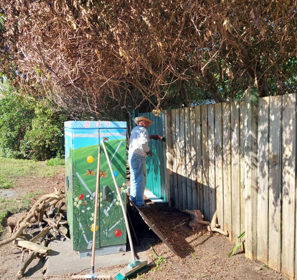 Person working on outdoor mini-golf game board
