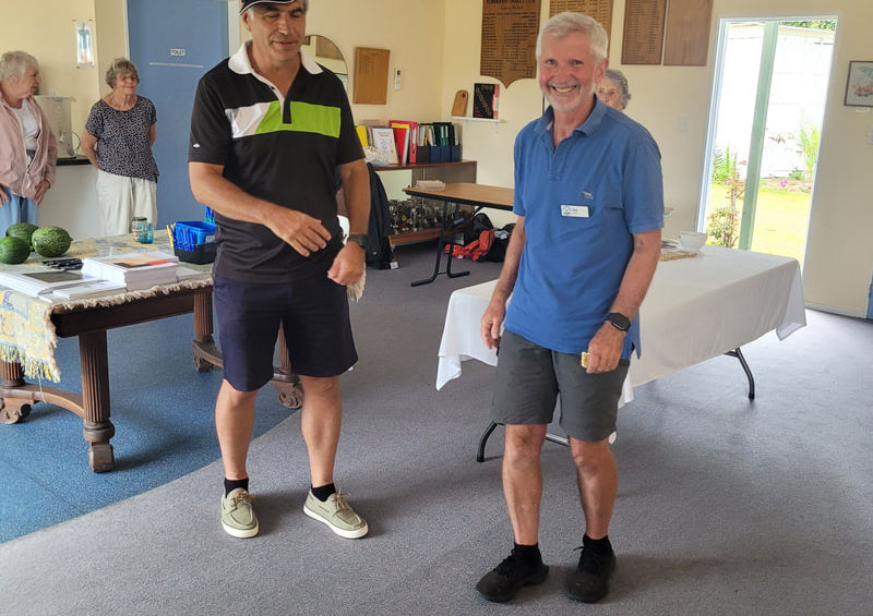 Two men conversing at an indoor event