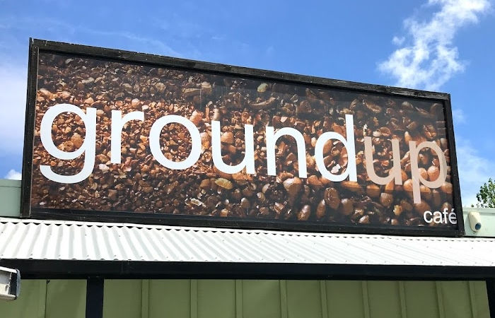 Groundup cafe sign with coffee bean background