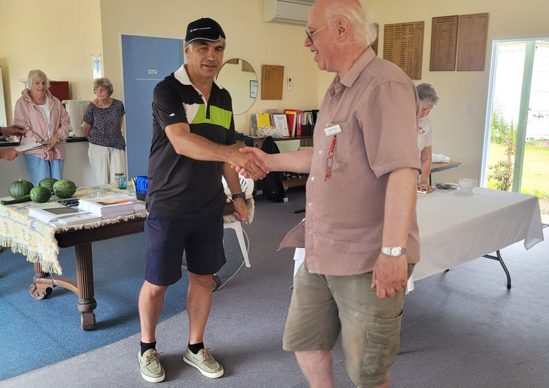 Two men shaking hands in a room
