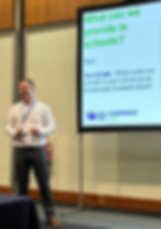 Neil Moggan of Future Action on stage at an event