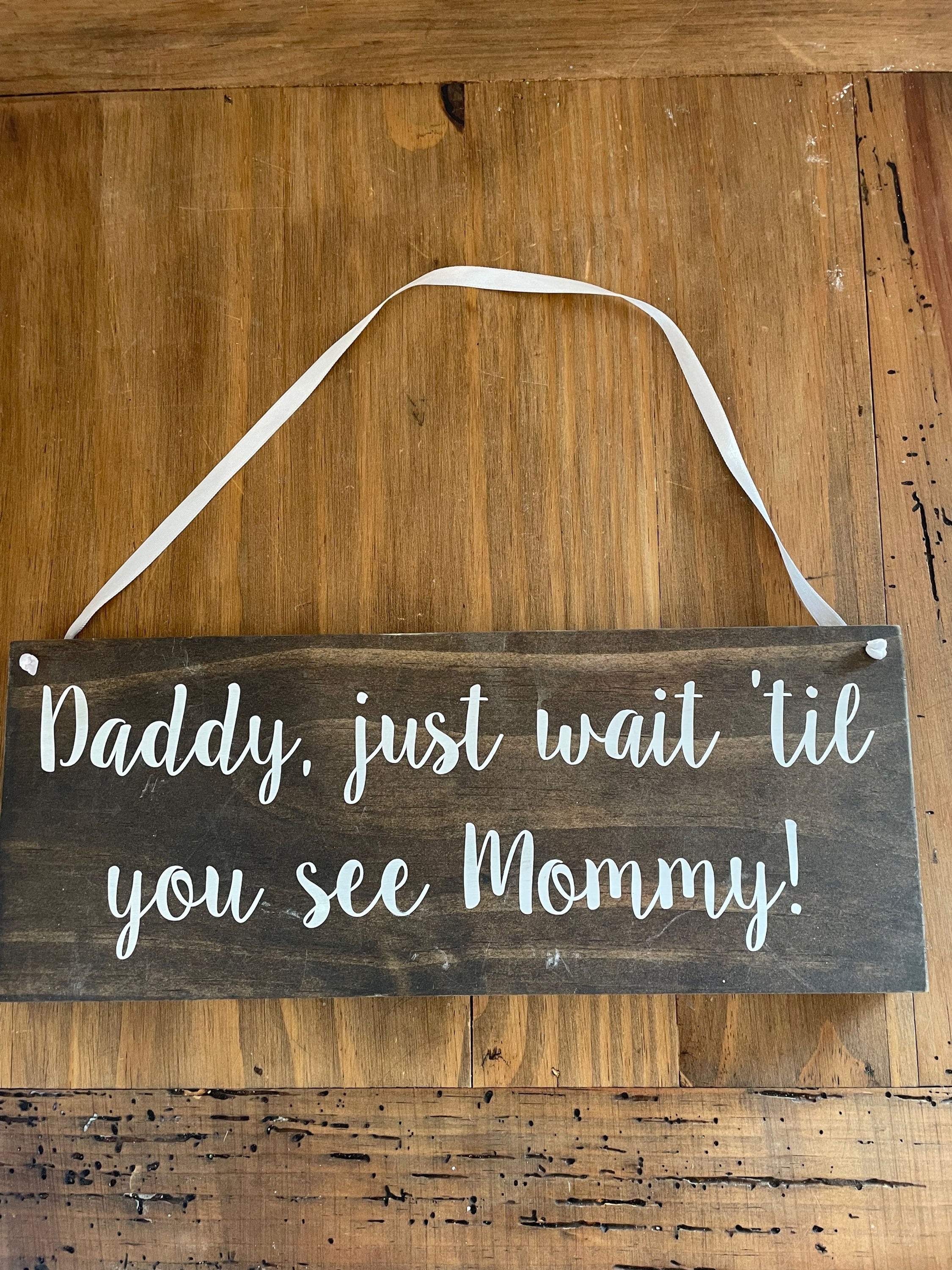 Hanging “daddy wait until you see mommy” Signage
