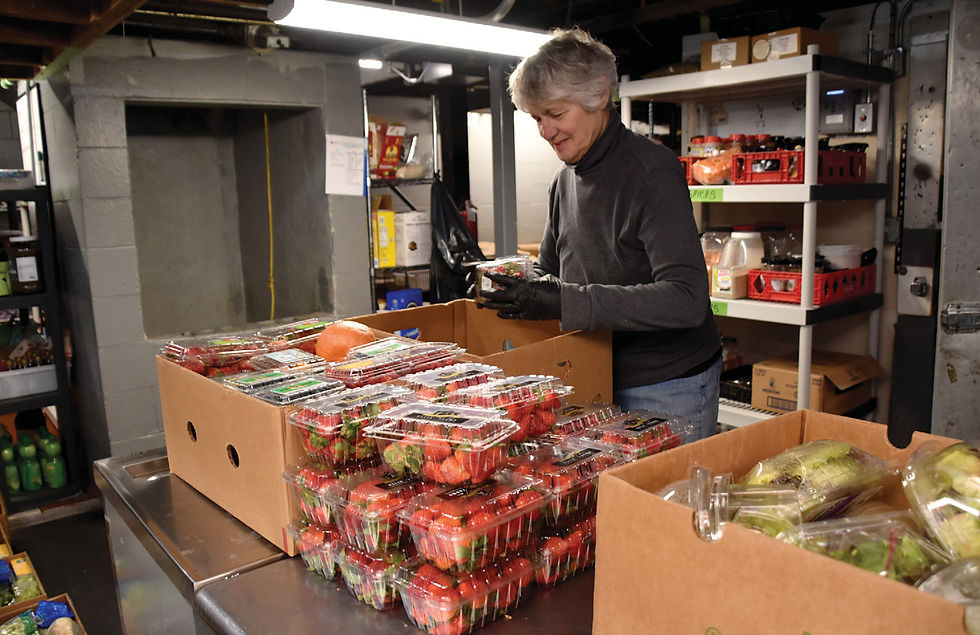 Heather Delvecchio sorts through food donations arriving at FTC.