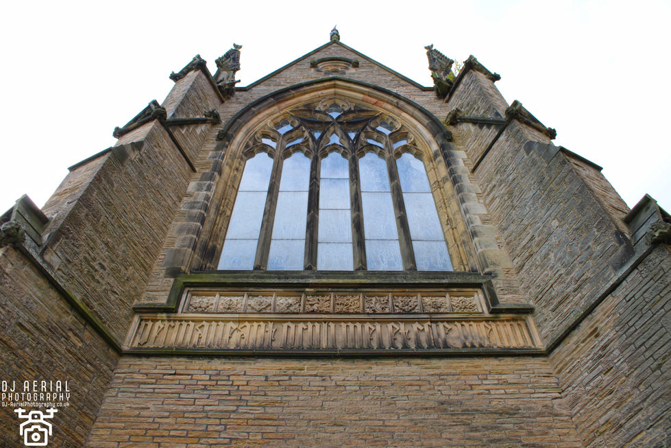 a brick building with a large window and a stone plaque that says ' a ' on it