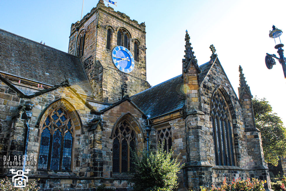 a church with a blue clock on the top of it
