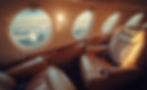 vecteezy_luxurious-interior-of-a-private-jet-with-sunset-view-over_60283374.jpeg