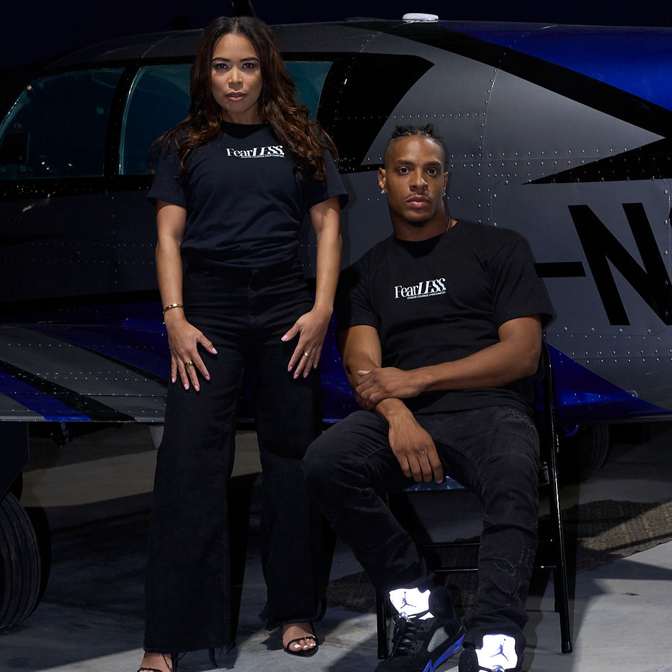 Male and female models wearing the FearLESS short sleeve shirt, showcasing the bold design and comfortable fit.