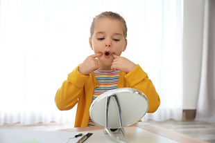 Child working on speech sounds during speech therapy