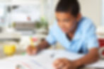 Middle school child writing with a pencil