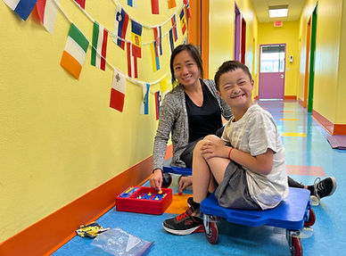 Physical Therapist working with a child on core strength and balance