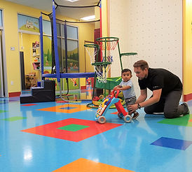 Child receiving physical therapy to learn to walk