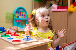 Child with Down Syndrome working on speech sounds during speech therapy
