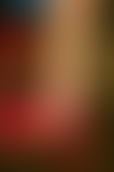 close up photo of a foot in high heel with very long toenails, propped up on a red chair