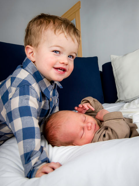 Photography of big brother with newborn baby.