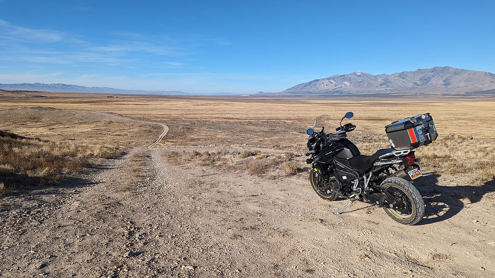 A motorcycle parked overlooking a vast desert