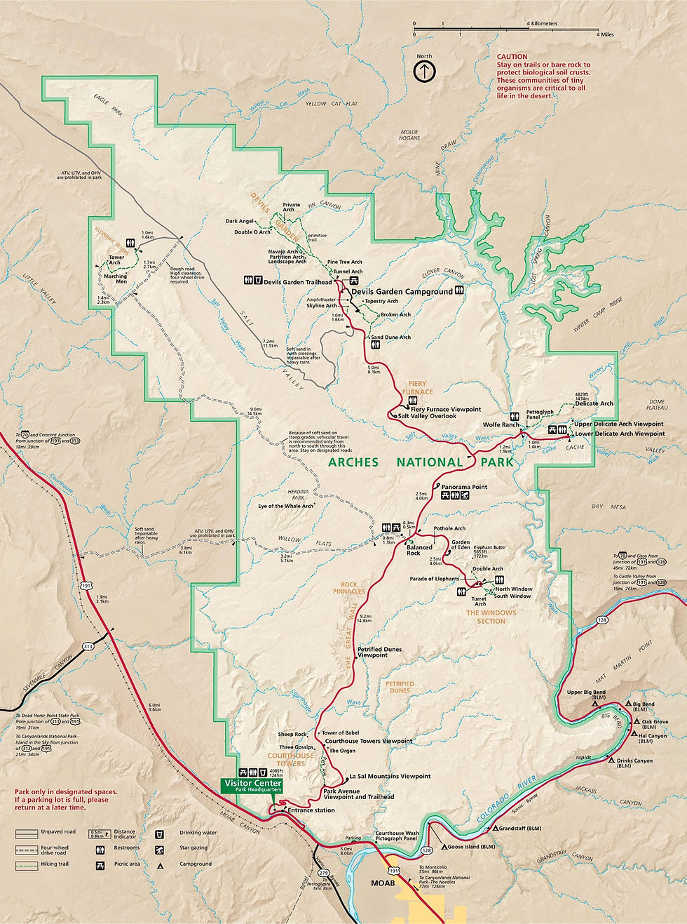 Map of Arches National Park with trails, campsites, and viewpoints marked. Red routes indicate main roads, green hues show park boundaries.