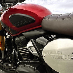 A very clean motorcycle engine closeup and red tank