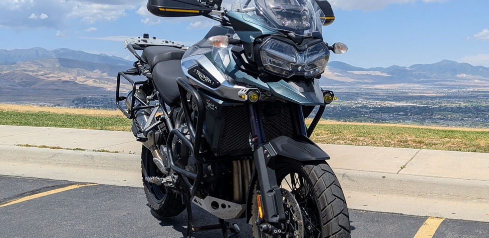 A green motorcycle, seen from the front, parked