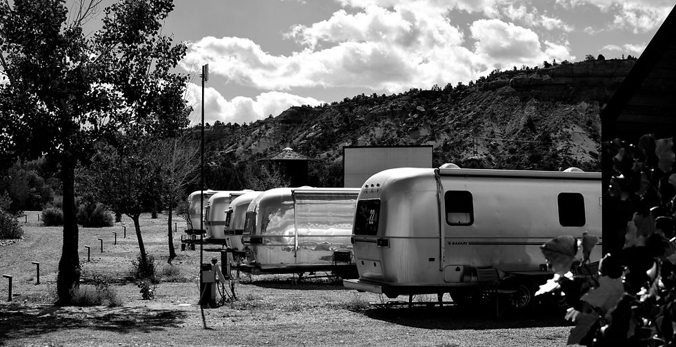 A line of Airstream campers parked at a campground