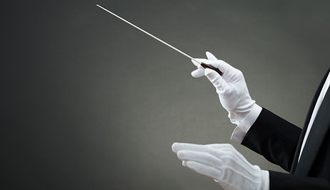 Cropped image of music conductor's hand instructing with baton against gray background.jpg