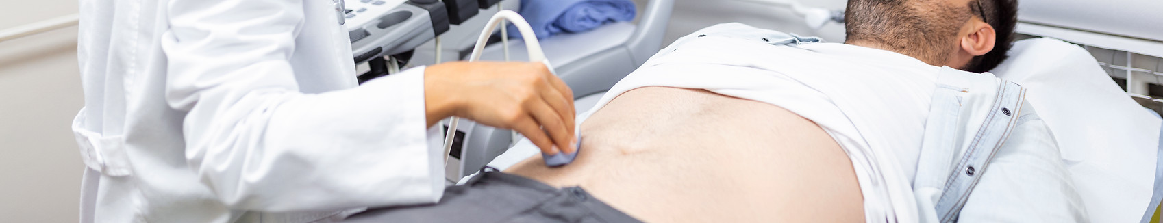 careful-female-doctor-white-coat-sitting-front-ultrasound-apparatus-conducting-abdominal-d