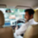 A chauffeur in a white uniform looks back and smiles.