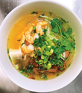 Egg noodles with chicken broth, shrimp, roasted pork, ground chicken, celery, onions, and cilantro