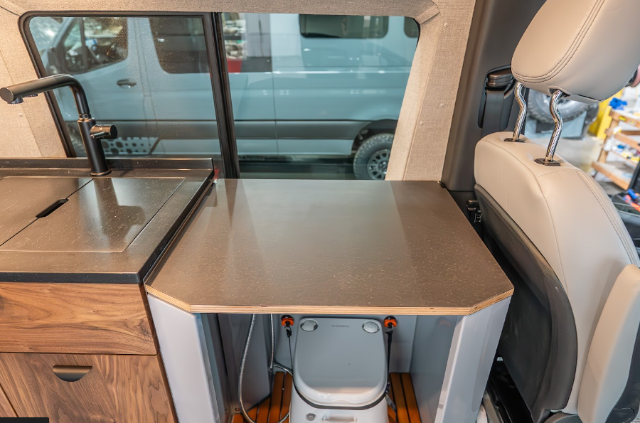Convertible Shower Lid Used as Counter Space in an Off Highway Van
