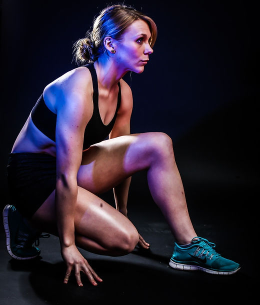 Coach Colline LGBTQ+ Nutritionist and Personal Trainer in and athletic stance