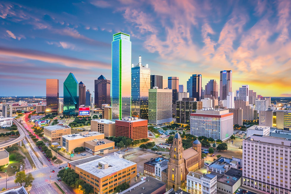 Vibrant Dallas skyline at sunset with colorful reflections on the buildings and a clear view of the city’s architecture.