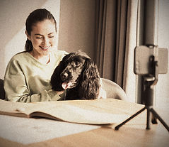 Happy young brunette woman studying online remotely from her house while sitting in front
