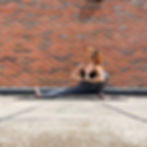 A yoga teacher demonstrating skandasana