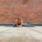 A yoga teacher demonstrating half middle splits