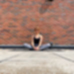 A yoga teacher demonstrating baddha konasana