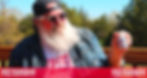 A bearded man in sunglasses holds a campaign-branded medicine bottle outdoors.