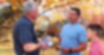 Pat Condon speaks with a father and son outside on an autumn afternoon.