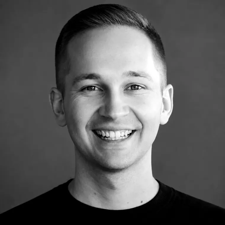 Black-and-white portrait of Brent Comstock, founder of BCom Solutions