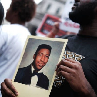 Protester holds photograph of Eric Garner