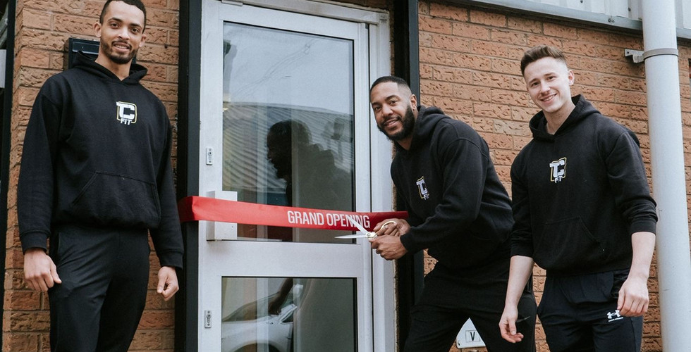 TCFit trainers Chris, Liam and Tony cutting ribbon on TCFit door to celebrate opening