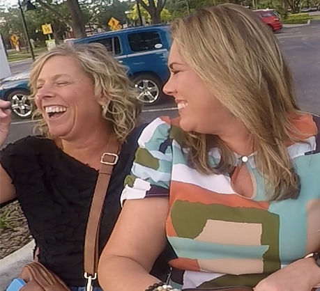 Two woman have laughs while taking a pedicab tour on International Drive.