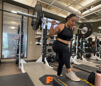Women doing barbell step up in all black