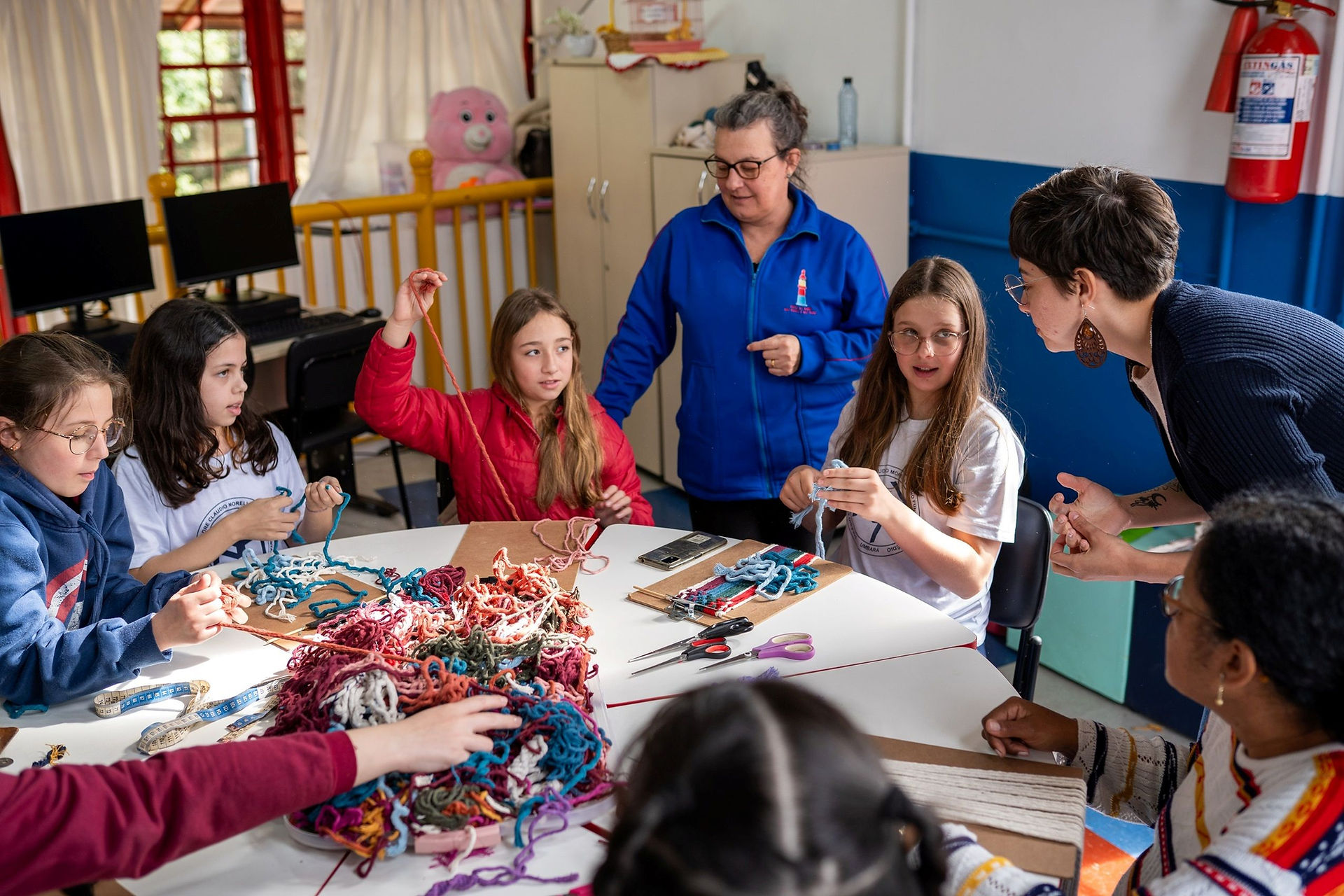 Participantes aprendendo macramê em oficina do projeto Arte em nós