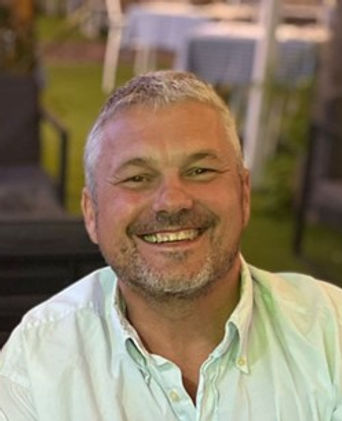 man smiling warmly looking confident and friendly