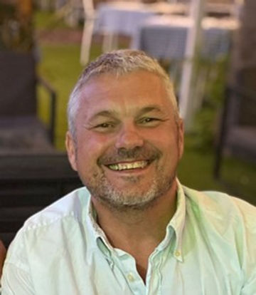 man smiling warmly looking happy and confident