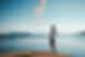 Man standing on mountain with arms in the air feeling happy