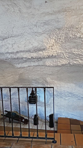 Escaleras de casa cueva con paredes de roca en Alcalá del Júcar