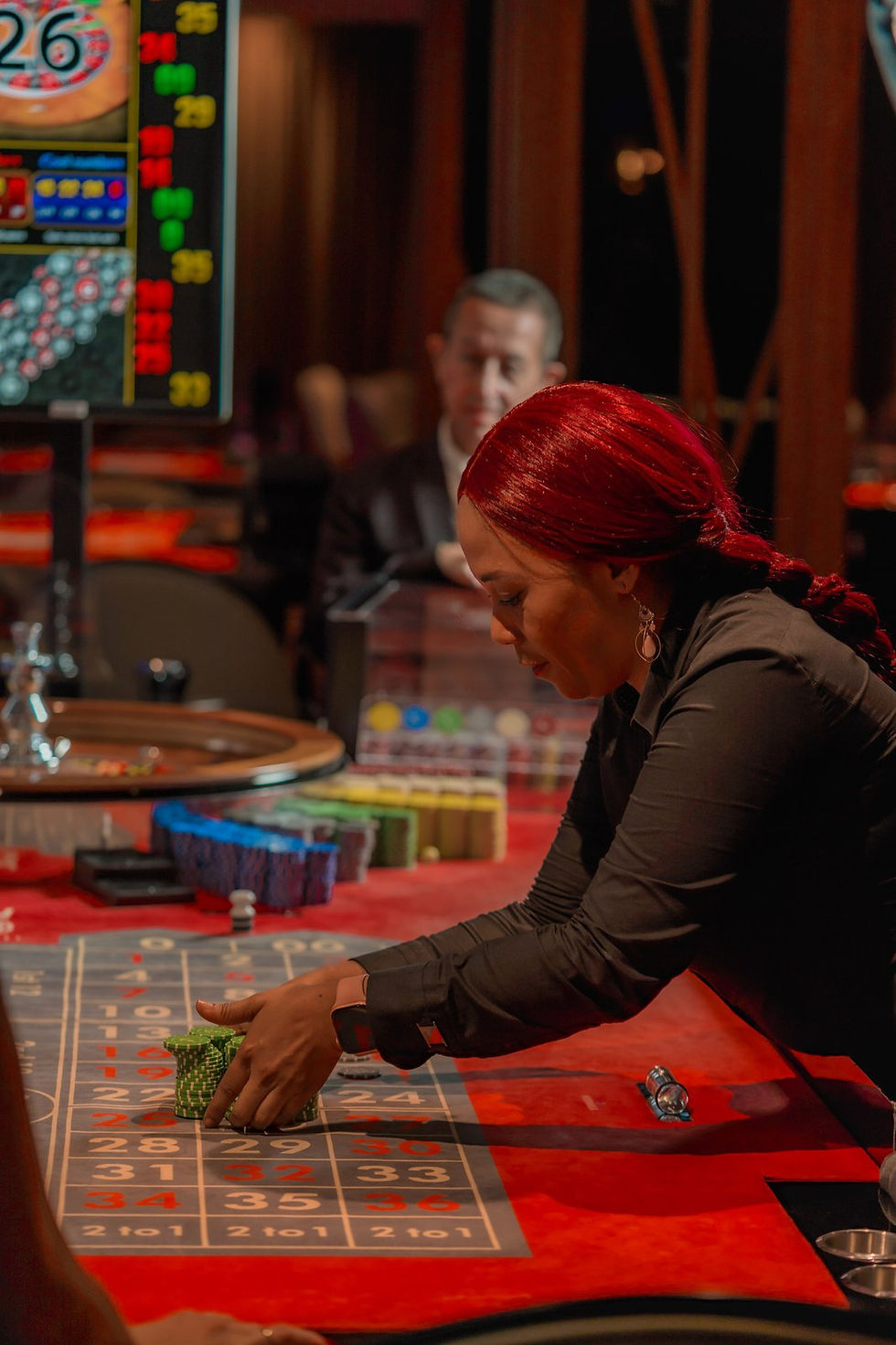 Croupier arranging chips on the roulette table at Casino Dominic, Fishing Lodge Cap Cana